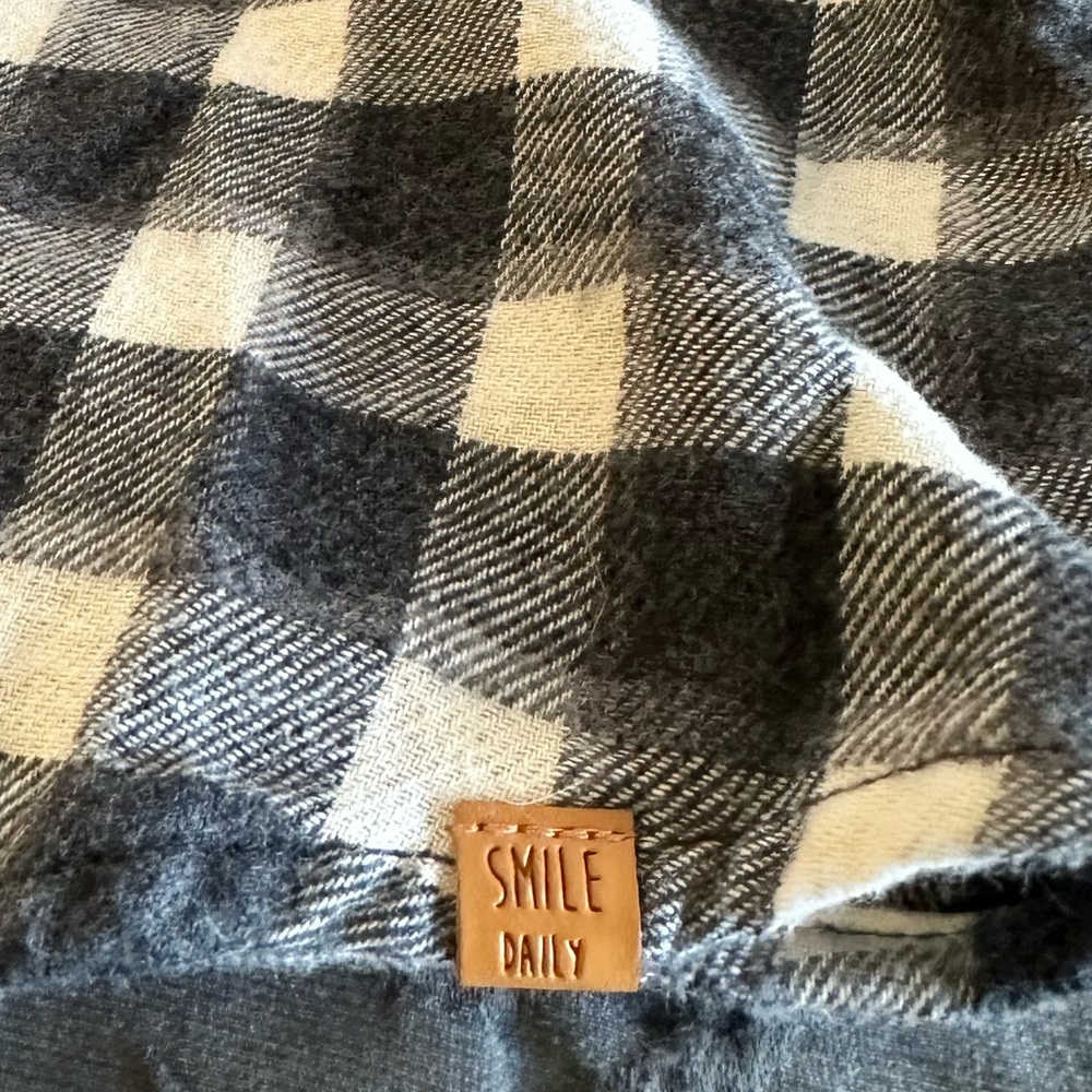 Young child’s light flannel shirt with front pocket and simple collar.